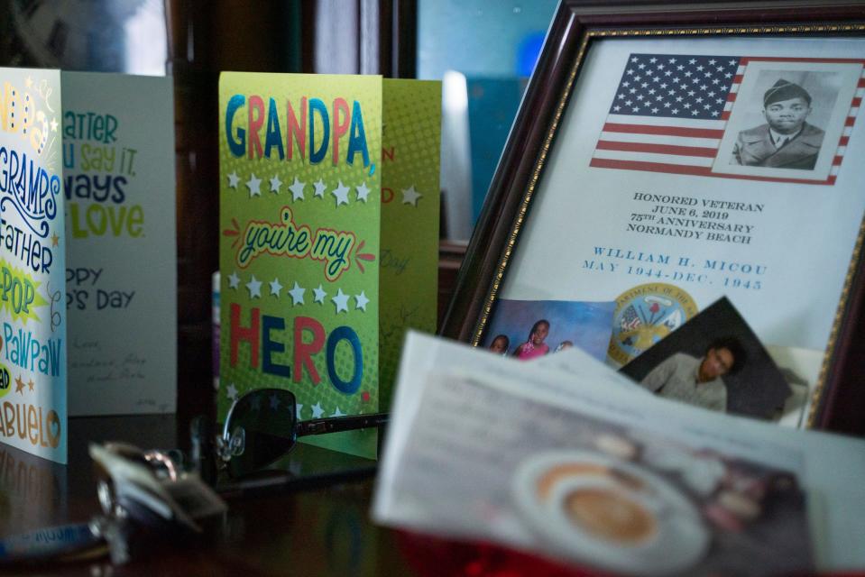 Birthday cards and photographs sit on the dresser of William Henry Micou, now 99, a military veteran and Red Ball Express driver during World War II, inside his room at American House Senior Living in Farmington Hills on Monday, August 21, 2023.