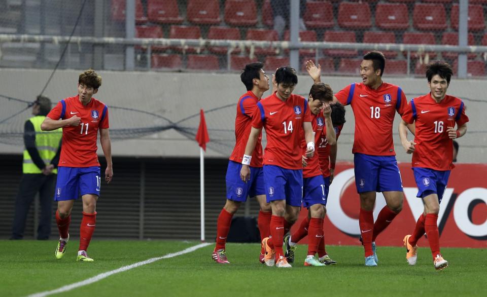 South Korea's Son Heungmin, left, with his teammates celebrates after scoring the second goal of his team during a friendly match at Georgios Karaiskakis stadium against Greece in Piraeus port, near Athens, Wednesday, March 5, 2014. (AP Photo/Thanassis Stavrakis)