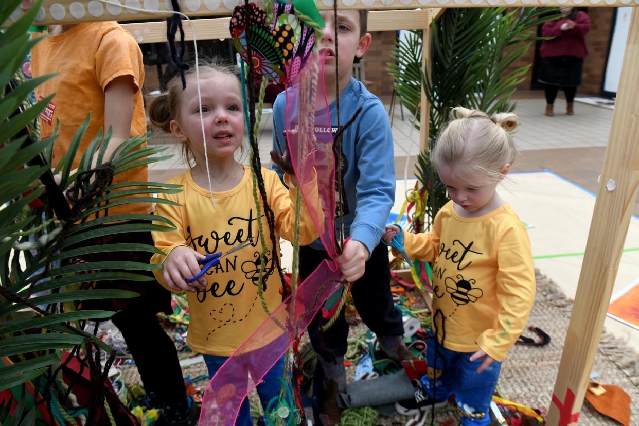 Siblings Zaphyra Jordan, 5, Flynn Jackson, 7 and Esther Jordan, 3, of Robertsville, participate in "Go Big! WPA Mural Artist Celebration" part of School's Out Free Mondays event at the Canton Museum of Art.