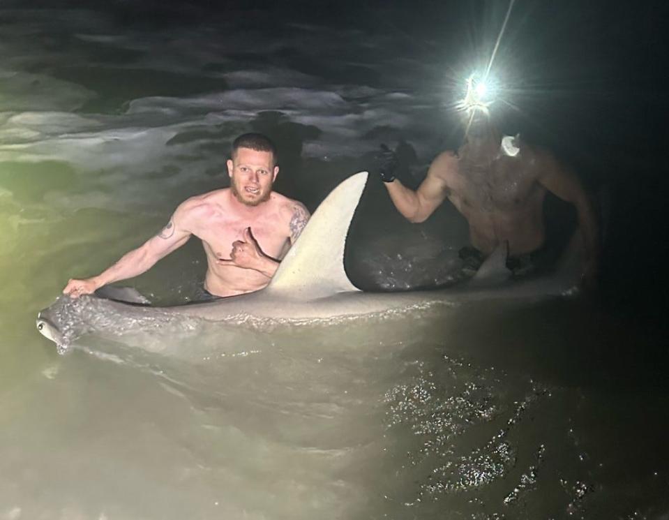 Here's Tyler from Oak Hill with quite a catch: A 9-foot hammerhead brought to the beach with the help of the NSB Shark Hunters.
