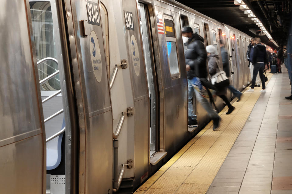 NEW YORK, NEW YORK - JANUARY 19: People board a subway on January 19, 2022 in New York City. The New York City subway system, the nation's largest, has come under increasing scrutiny following the violent death of a 40-year old woman last week in the Times Square subway station. Michelle Go was pushed by a homeless man with a psychiatric history into an oncoming train. The event has shocked New Yorkers and increased pressure on the new mayor, Eric Adams, to add police and homeless outreach teams to the city's subways.  (Photo by Spencer Platt/Getty Images)