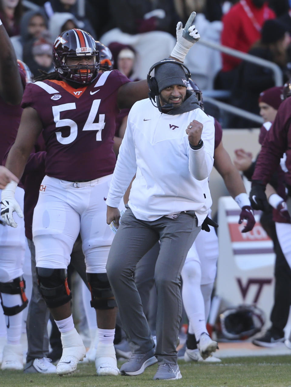 Virginia Tech defensive coordinator Justin Hamilton celebrates a defensive stop against Duke in the first half of an NCAA college football game in Blacksburg Va., Saturday, Nov. 13 2021. (Matt Gentry/The Roanoke Times via AP)