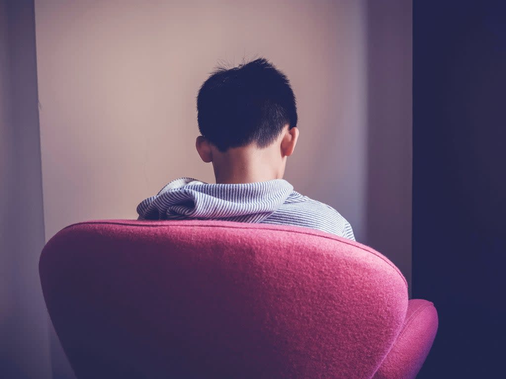 Boy sits alone in chair facing the wall (Getty Images/iStockphoto)