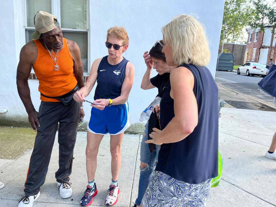 Dr. Sandra Gibney, second from left, and Lt. Gov. Bethany Hall-Long, far right, show Wilmington residents how to use new xylazine-fentanyl test strips.