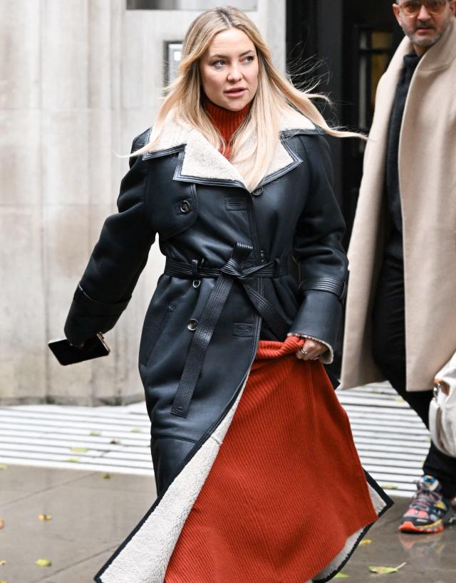 Pregnant Lara Bingle covers up her baby bump in a winter coat in