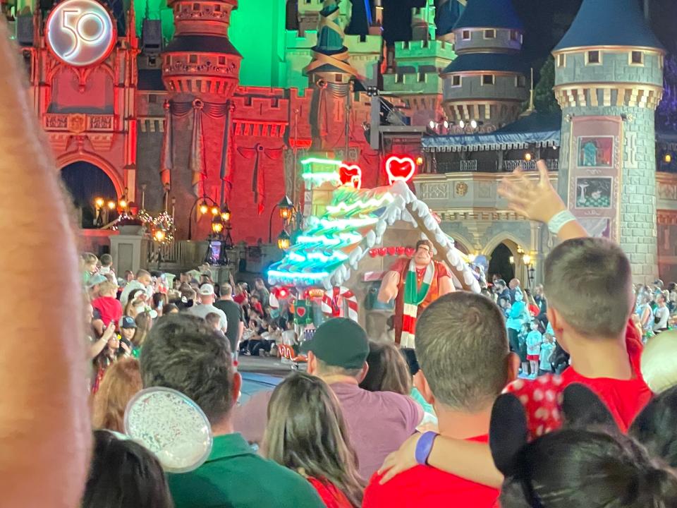 crowds gathering to watch the christmas parade at magic kingdom in disney world