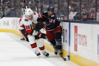 Ottawa Senators' Nikita Zaitsev, left, of Russia, and Columbus Blue Jackets' Nathan Gerbe chase the puck during the second period of an NHL hockey game Monday, Feb. 24, 2020, in Columbus, Ohio. (AP Photo/Jay LaPrete)