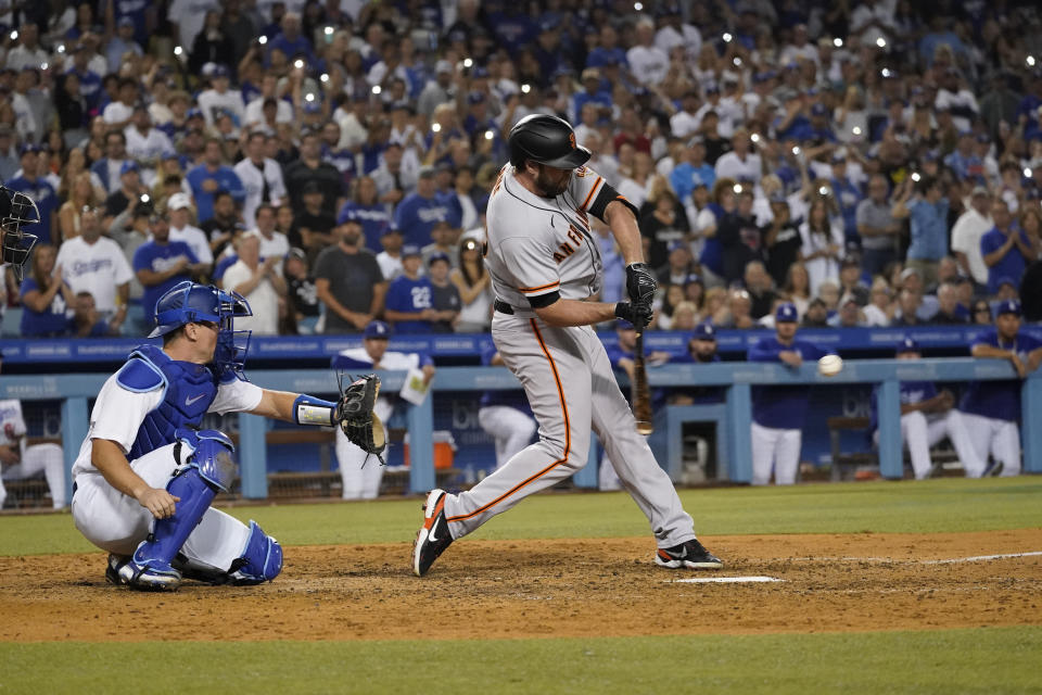 San Francisco Giants' Darin Ruf connects for a grand slam during the seventh inning of the team's baseball game against the Los Angeles Dodgers on Thursday, July 21, 2022, in Los Angeles. (AP Photo/Marcio Jose Sanchez)