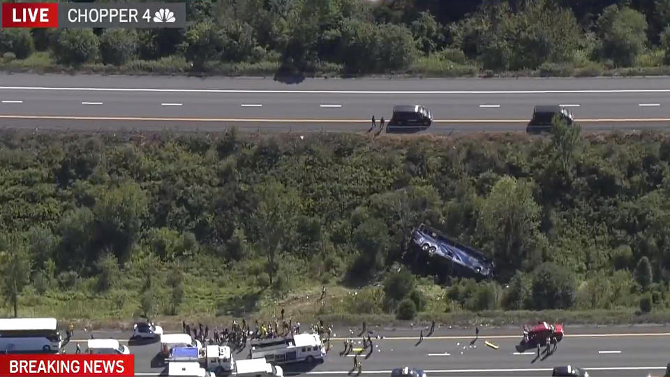 Emergency responders work the scene of a fatal bus crash, in Wawayanda, N.Y., Thursday, Sept. 21, 2023. The charter bus carrying high school students to a band camp hurtled off a New York highway and down an embankment, officials said. (NBC New York via AP)