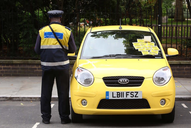 A traffic warden stands beside a car in central London which has been ticketed as part of a new T-Mobile advert where the brand has handed out thousands of pounds in Â£5, Â£10, Â£20 and Â£50 notes inside imitation parking fines on cars in and around the Capital. PRESS ASSOCIATION Photo. Issue date: Tuesday September 13, 2011. T-Mobile secretly filmed the reactions from unsuspecting members of the public for a new TV advert which launches on Friday night 9.15pm on Channel 5. Photo credit should read: Geoff Caddick/PA