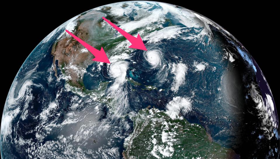 satellite image of earth shows two hurricanes one in the gulf of mexico and another close by in the atlantic ocean