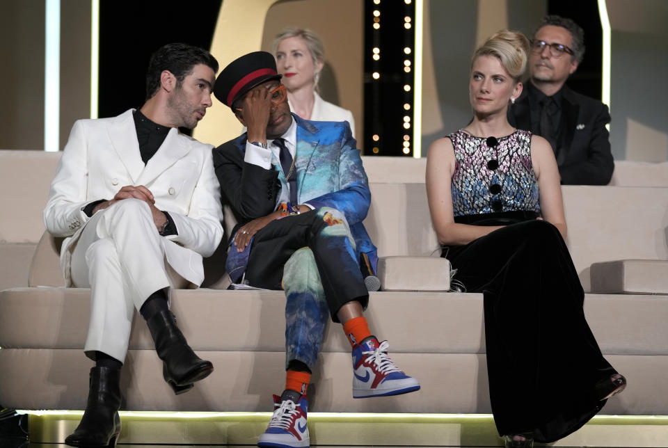 Jury president Spike Lee, center, holds his head in hands after accidentally revealing the film 'Titane' as the winner of the Palme d'Or as jury members Tahar Rahim, left, Jessica Hausner, back center, and Melanie Laurent look on during the awards ceremony at the 74th international film festival, Cannes, southern France, Saturday, July 17, 2021. (AP Photo/Vadim Ghirda)