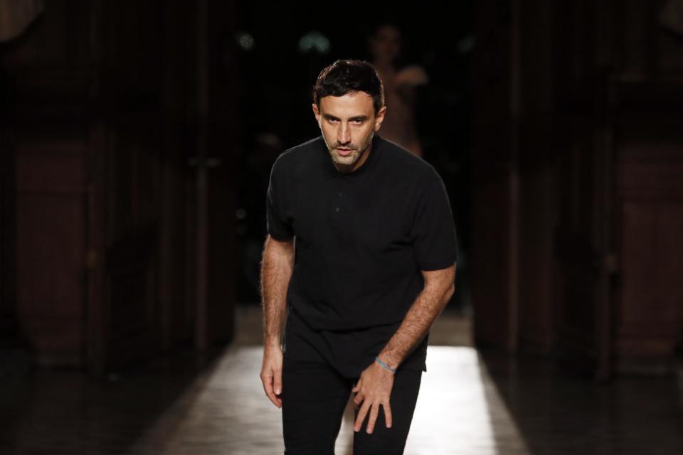 Italian designer Riccardo Tisci acknowledges applause at the end of Givenchy Men's Fall Winter 2017-2018 fashion collection presented in Paris, Friday, Jan. 20, 2017. (AP Photo/Francois Mori)