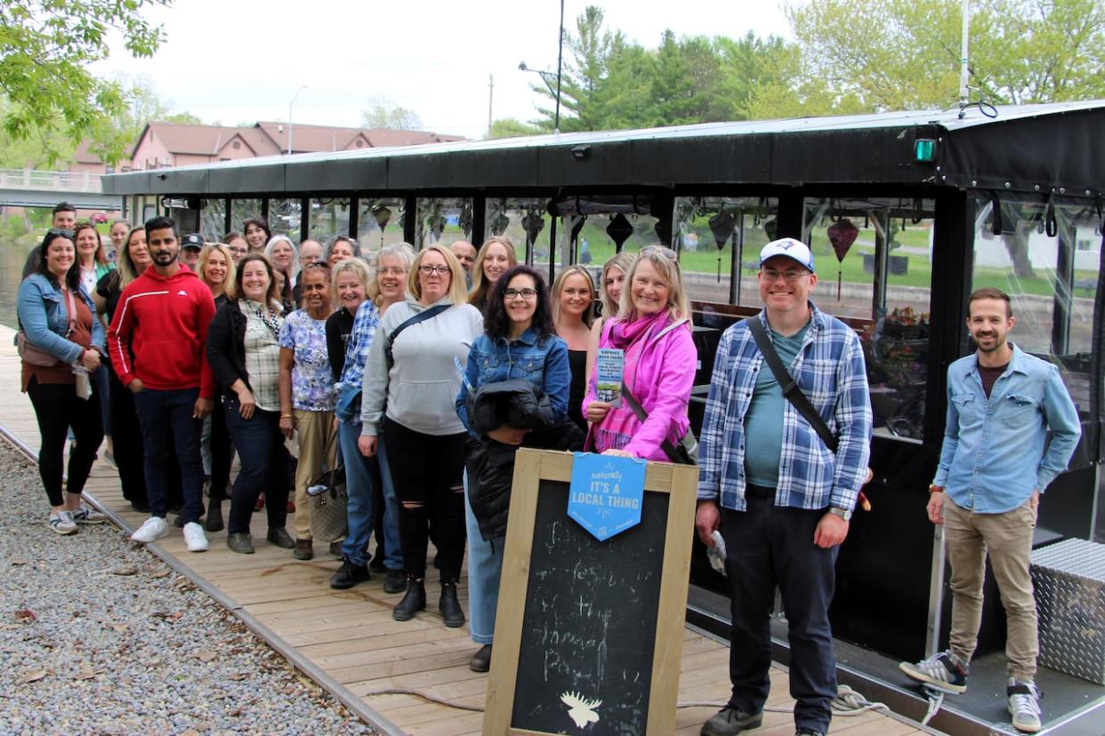 The businesspeople participating in the tour pose in front of the Napanee River Tours' boat on May 15, 2024. (Submitted by Rob Plumley - image credit)