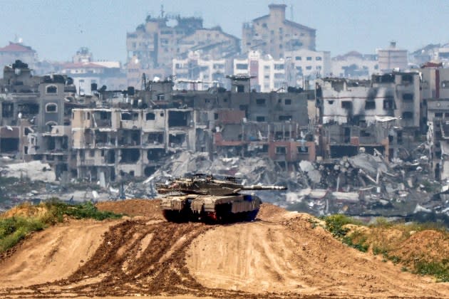 An Israeli army battle tank on the border of Palestinian territory. - Credit: Jack Guez/AFP/Getty Images