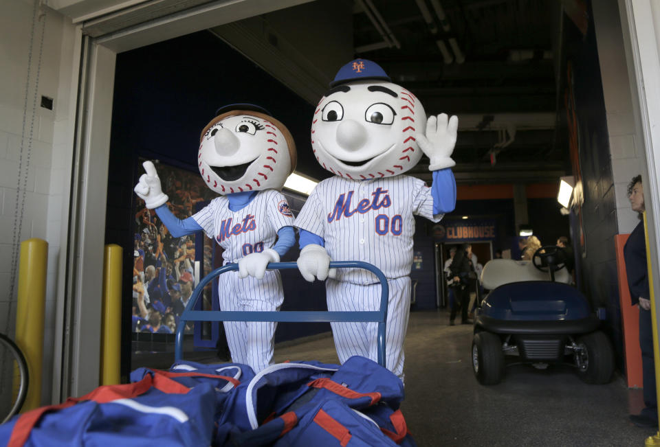 FILE - New York Mets mascots Mr. and Mrs. Met pose for pictures with the team's equipment before it is sent to spring training, at Citi Field in New York, Monday, Feb. 4, 2019. New York's Edwin Díaz has become baseball's most dominant closer this year and turned into the toast of the town with the Mets. Part of Díaz’s newfound popularity in Queens is his catchy entrance song “Narco” by Blasterjaxx & Timmy Trumpet. The tune sets off a two-minute fiesta all around Citi Field, with dancing mascots Mr. and Mrs. Met pretending to play trumpets as Díaz warms up on the mound. (AP Photo/Seth Wenig, File)