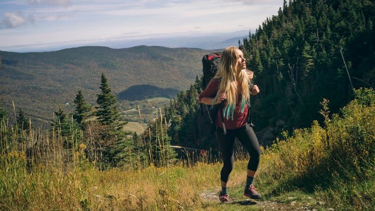 Woman hiking on a rocky ridgeline of Mt. Mansfield, Vermont