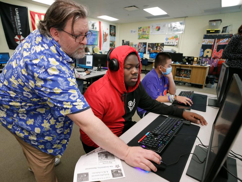 Teacher Paul Reed instructs Sherman Edmond in the CTE program classes at Mainland High School, Tuesday, Feb.14, 2022.