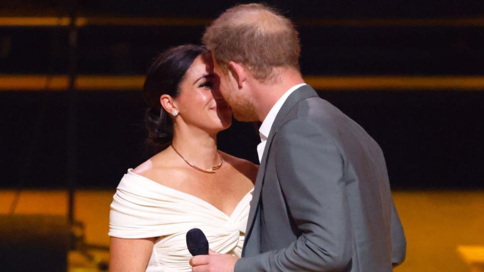 Meghan, Duchess of Sussex and Prince Harry, Duke of Sussex kiss whilst on stage during the Opening Ceremony of the Invictus Games 2020 at Zuiderpark on April 16, 2022 in The Hague, Netherlands. (Photo by Max Mumby/Indigo/Getty Images)