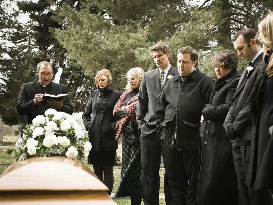 Christian burial traditions have deeply shaped the U.S. funeral industry. <a href="https://www.gettyimages.com/detail/photo/people-at-a-funeral-royalty-free-image/104302968?phrase=christian+burial+service&adppopup=true" rel="nofollow noopener" target="_blank" data-ylk="slk:RubberBall Productions/Brand X Pictures via Getty Images;elm:context_link;itc:0;sec:content-canvas" class="link ">RubberBall Productions/Brand X Pictures via Getty Images</a>