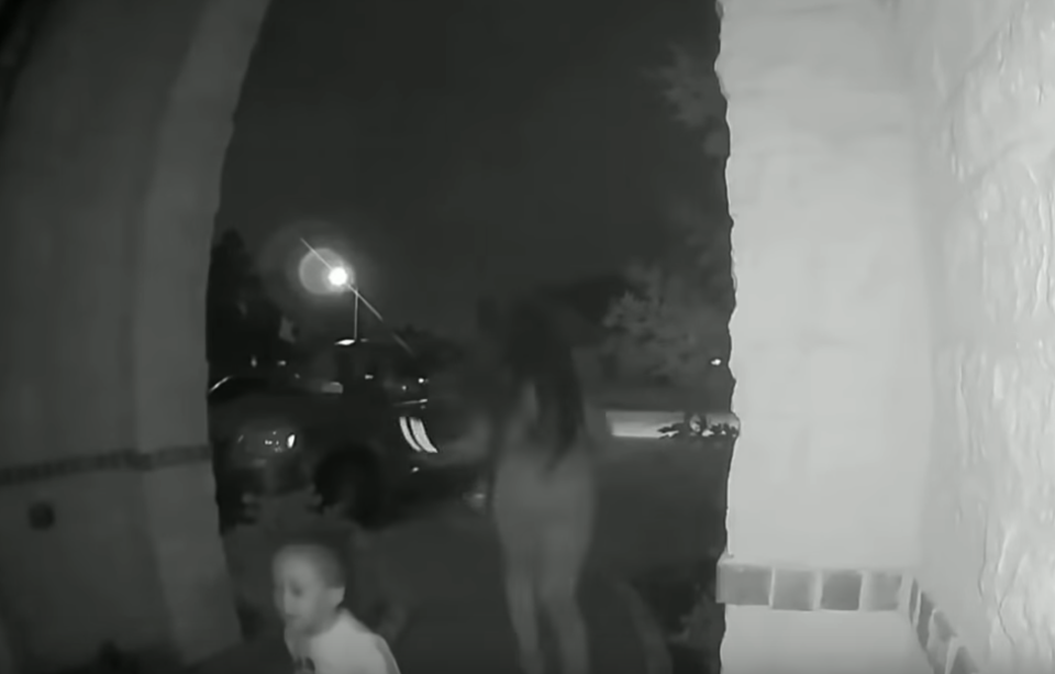 <em>After ringing the doorbell and knocking on the door, the woman runs off, leaving the child on the doorstep (Picture: YouTube/Montgomery County Sheriffs)</em>
