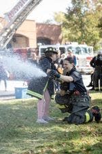 Alannah Scardino, a Brighton volunteer firefighter, has fun spraying a fire hose.