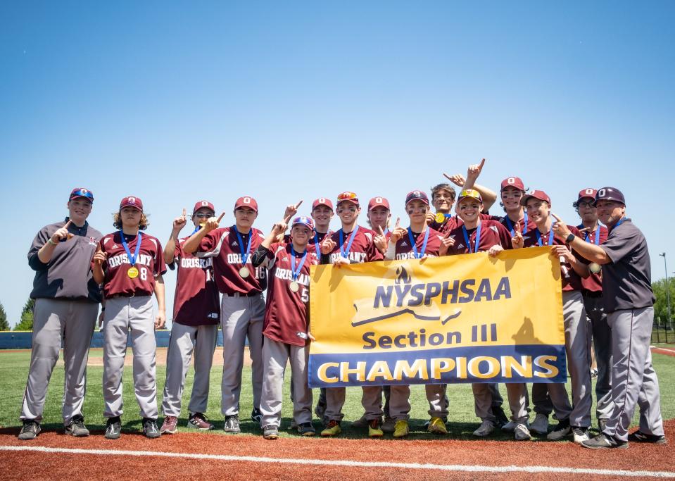 Oriskany poses with its championship banner after defeating Belleville-Henderson 1-0 at Onondaga Community College Monday in the 2023 Section III Class D baseball final.