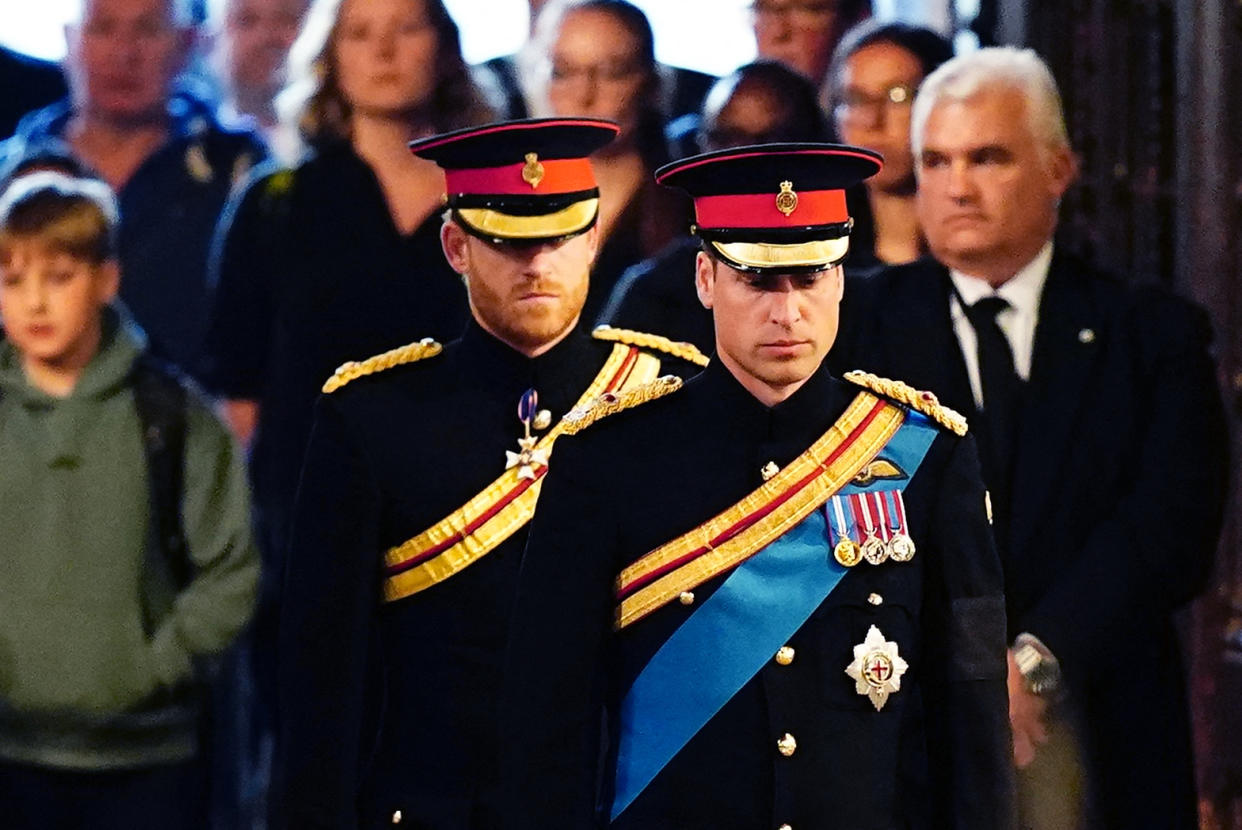 Queen Elizabeth II 's grandchildren (L-R) Britain's Prince Harry, Duke of Sussex (L) and Britain's Prince William, Prince of Wales (R) arrive to hold a vigil around the coffin of Queen Elizabeth II, in Westminster Hall, at the Palace of Westminster in London on September 17, 2022, ahead of her funeral on Monday. - Queen Elizabeth II will lie in state in Westminster Hall inside the Palace of Westminster, until 0530 GMT on September 19, a few hours before her funeral, with huge queues expected to file past her coffin to pay their respects. (Photo by Aaron Chown / POOL / AFP) (Photo by AARON CHOWN/POOL/AFP via Getty Images)