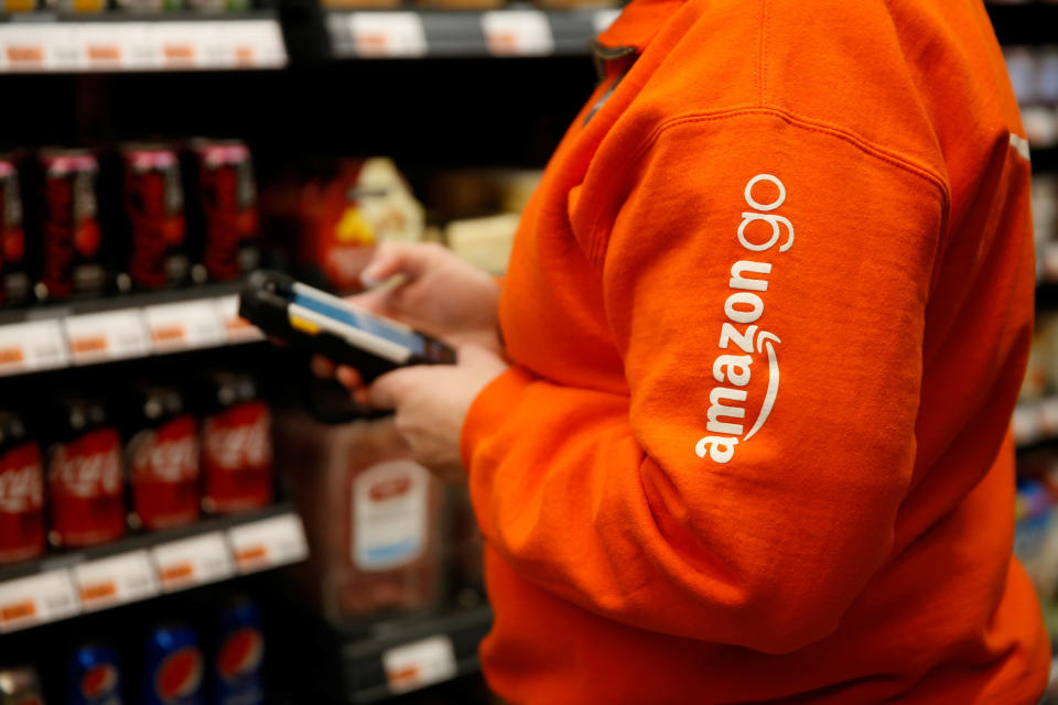 Amazon associate Cindy Umipig checks inventory at a smaller format Amazon Go store in the Blue Shift Amazon office space at 300 Pine Street in downtown Seattle, Washington, U.S., December 10, 2018. Picture taken December 10, 2018.  REUTERS/Lindsey Wasson