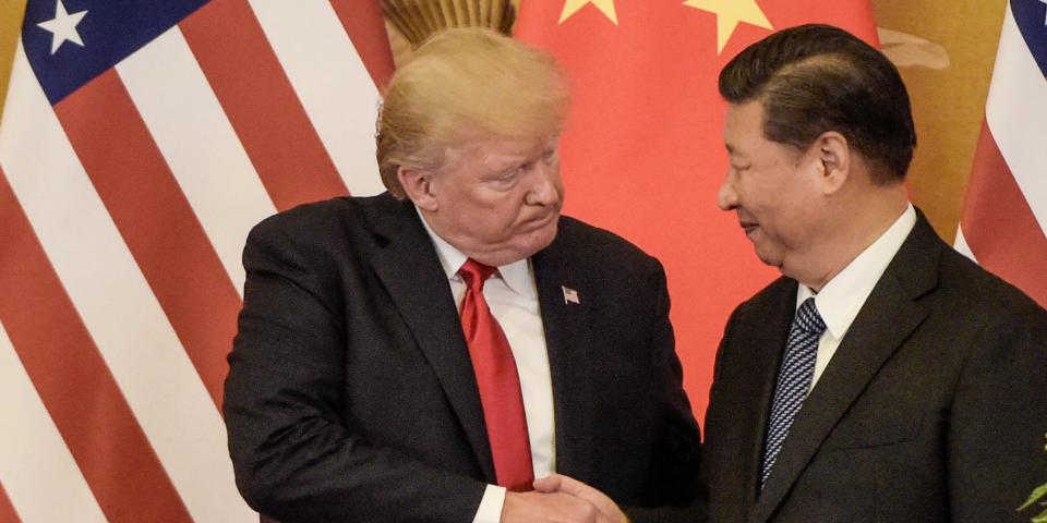 US President Donald Trump shakes hand with China's President Xi Jinping at the end of a press conference at the Great Hall of the People in Beijing on November 9, 2017.