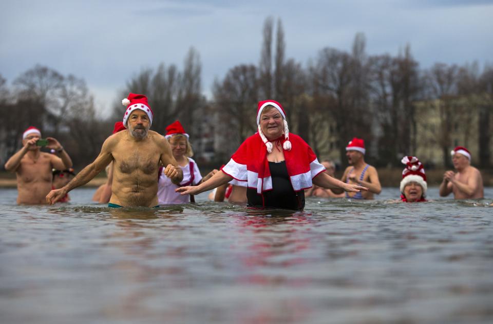 Members of ice swimmers club take dip in lake during their traditional Christmas swimming event in Berlin