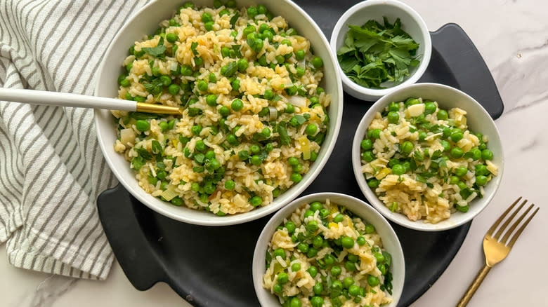 risi e bisi rice and peas in white bowls