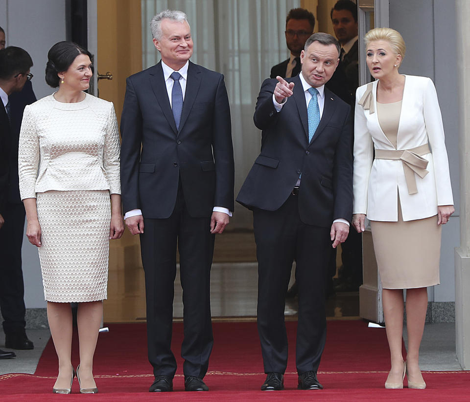 Lithuanian First Lady Diana Nausediene, Lithuanian President Gitanas Nauseda, his Polish counterpart Andrzej Duda and Poland's First Lady Agata Kornhauser-Duda attend a military welcome ceremony at the presidential Palace in Warsaw, Poland, Tuesday, July 16, 2019.(AP Photo/Czarek Sokolowski)