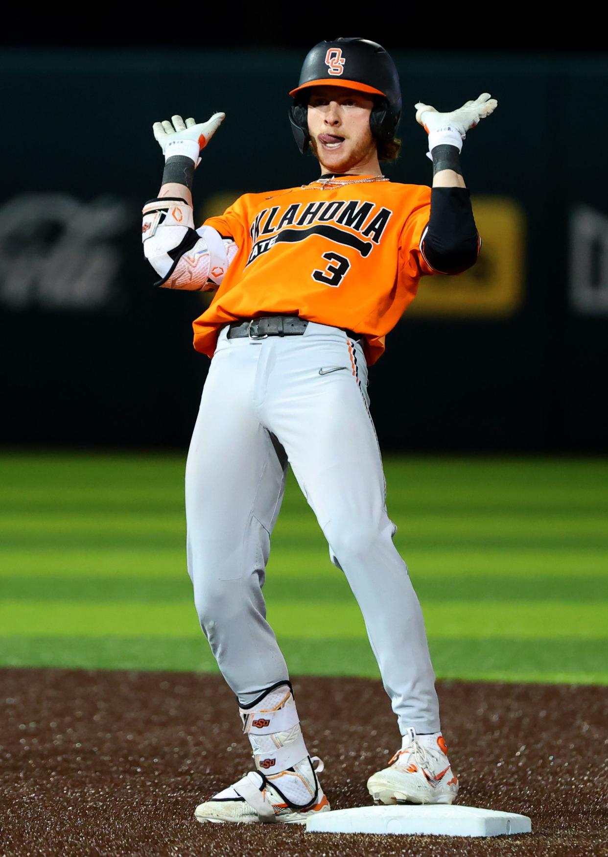 Oklahoma State's Carson Benge (3) celebrates a double during the college Bedlam baseball game between the University of Oklahoma Sooners and Oklahoma State University Cowboys in Norman, Okla., Tuesday, March 12, 2024.