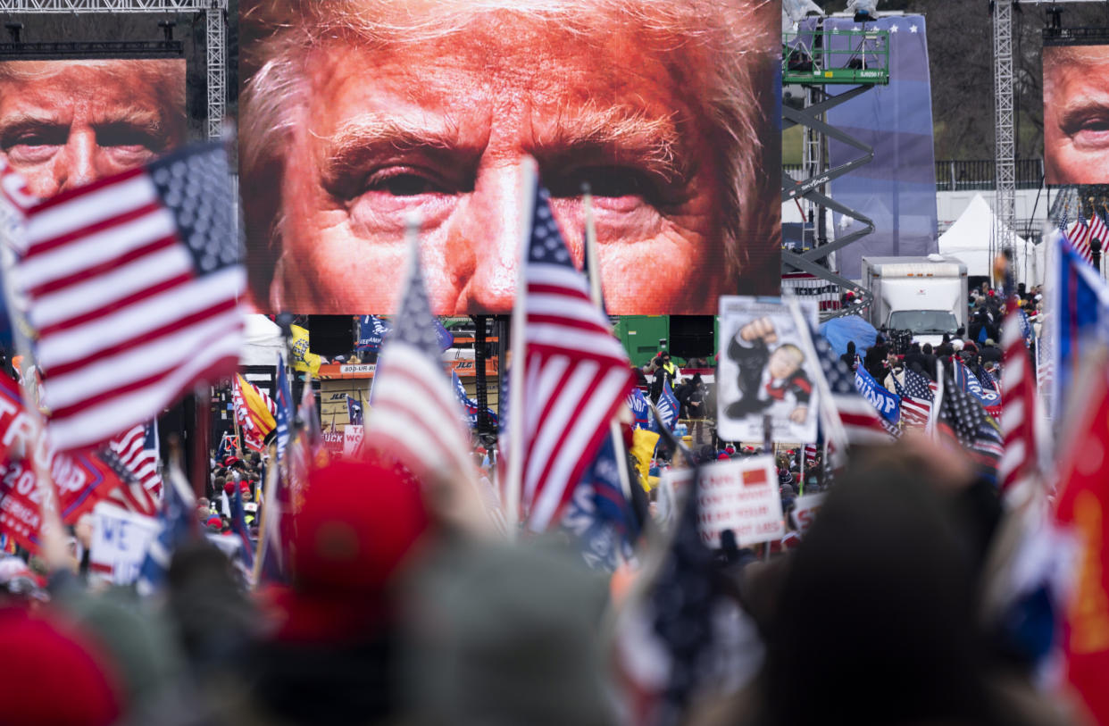 An image of President Donald Trump appears on video screens before his speech to supporters from the Ellipse at the White House, Jan. 6, 2021. (Photo: Bill Clark via Getty Images)