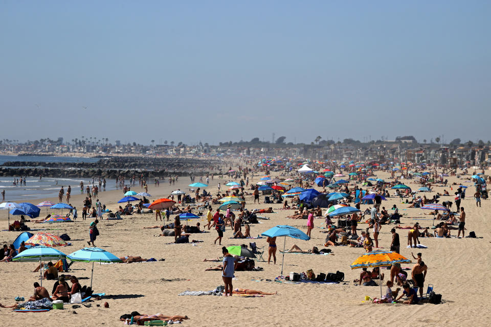 Crowds filled beaches in Newport Beach, California, last weekend as temperatures rose in Southern California. Many California counties have closed beach access. (Photo: Michael Heiman via Getty Images)