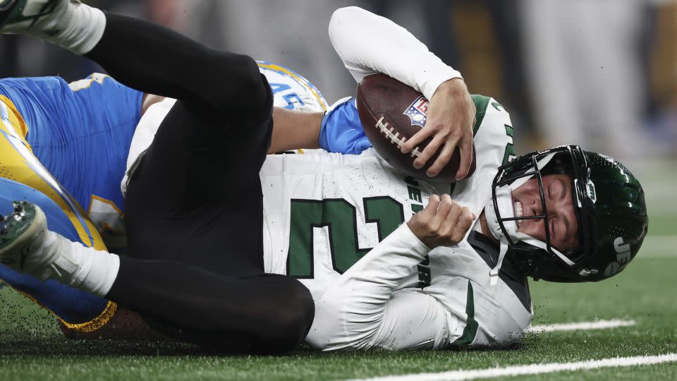 Zach Wilson is sacked by Tuli Tuipulotu during the fourth quarter. - Elsa/Getty Images