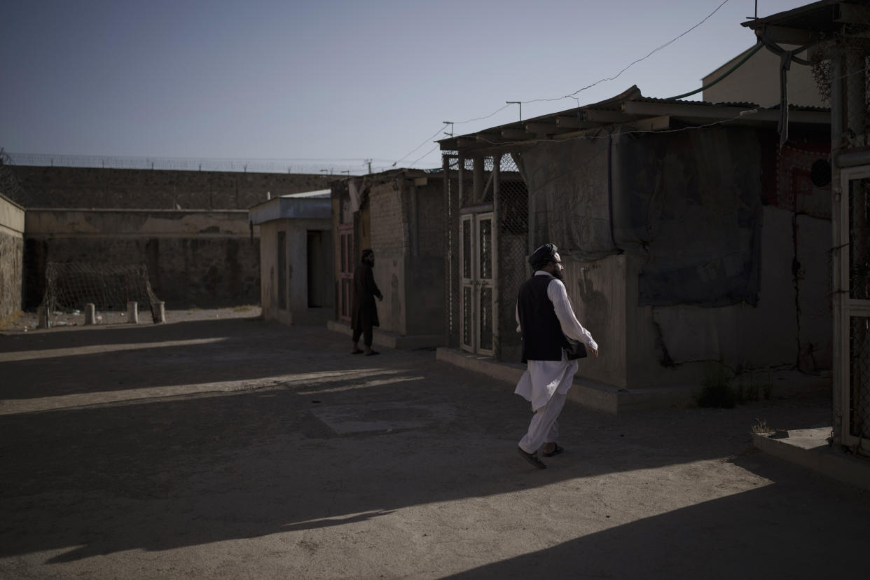 Taliban fighters walk through an empty area of the Pul-e-Charkhi prison in Kabul, Afghanistan, Monday, Sept. 13, 2021. Pul-e-Charkhi was previously the main government prison for holding captured Taliban and was long notorious for abuses, poor conditions and severe overcrowding with thousands of prisoners. Now after their takeover of the country, the Taliban control it and are getting it back up and running, current holding around 60 people, mainly drug addicts and accused criminals. (AP Photo/Felipe Dana)