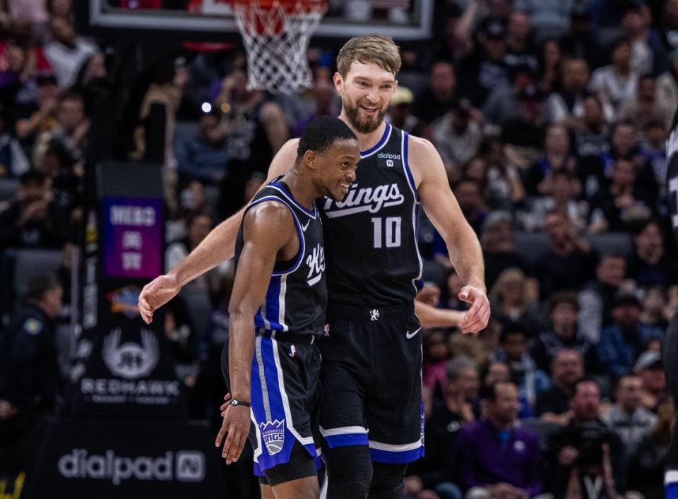 Sacramento Kings guard De’Aaron Fox (5) and center Domantas Sabonis (10) celebrate a basket during an NBA game against the San Antonio Spurs on Thursday at Golden 1 Center.