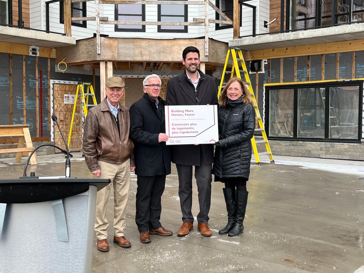 Federal Minister of Housing, Infrastructure and Communities Sean Fraser, second from right, announces $5.6 million for Pictou County towns through the housing accelerator fund at the Dunkeld apartment building in New Glasgow, N.S., on Friday. Fraser is also the area's MP. From left: Westville Mayor Lennie White, Pictou Mayor Jim Ryan and New Glasgow Mayor Nancy Dicks. (Town of New Glasgow - image credit)