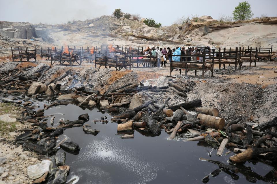 Bodies of people who died of Covid-19 are cremated at an open crematorium on the outskirts of BengaluruAP