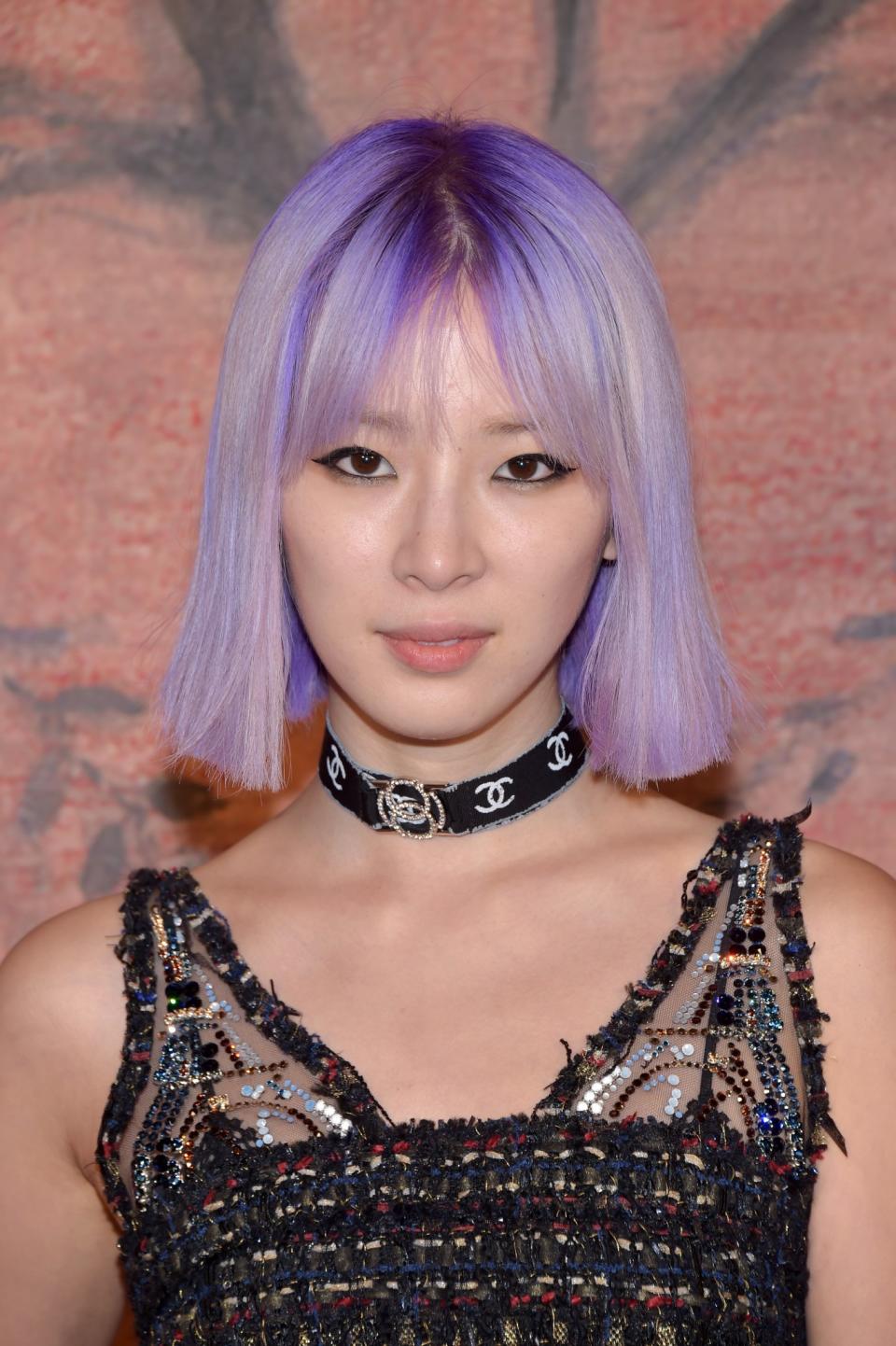 <p>The social media star and Estée Lauder global beauty contributor’s unicorn-purple hair is oh so dreamy. Simple black winged liner and pale pink lipstick complete this look. (Photo: Getty Images) </p>