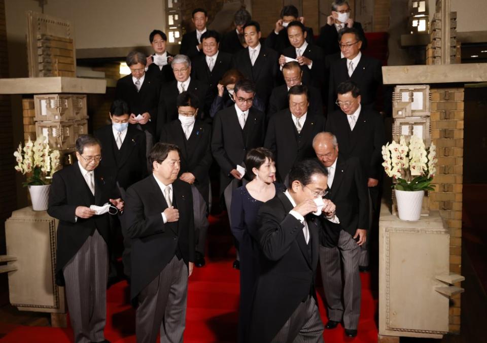 Ministers bow to Japan's Prime Minister Fumio Kishida as they leave a photo session at Kishida's residence in Tokyo on Aug. 10, 2022. Kishida reshuffled his cabinet on this day to rid his administration of any links to the Unification Church.<span class="copyright">Issei Kato—Pool/EPA-EFE/Shutterstock</span>