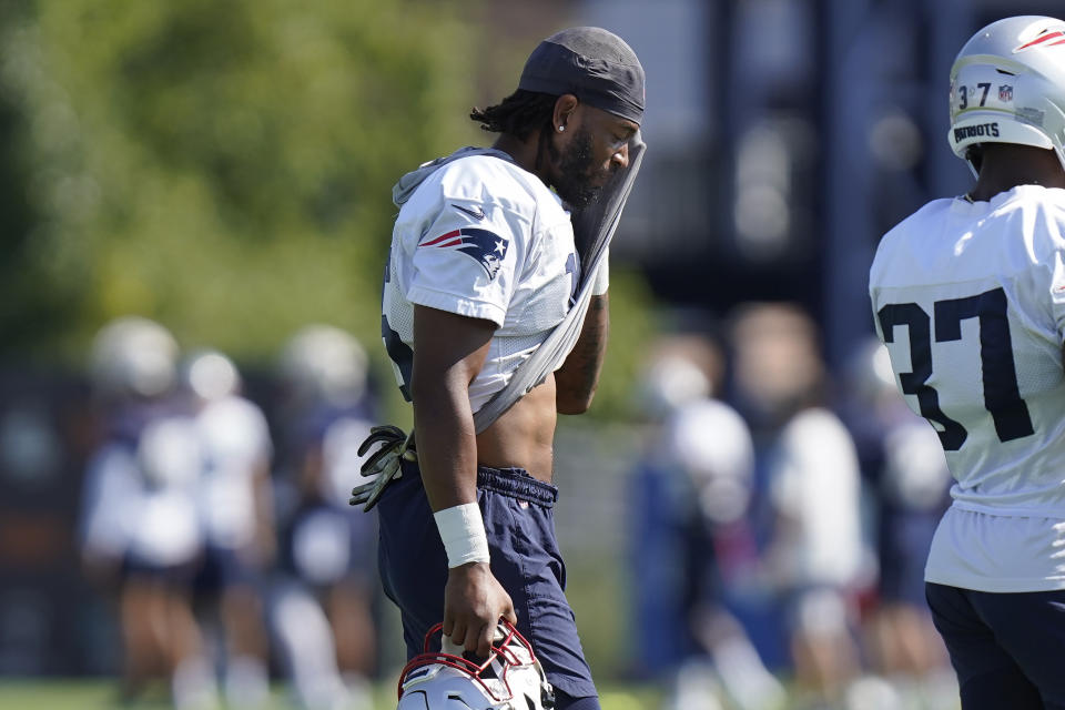 New England Patriots wide receiver Jakobi Meyers (16) wipes his face during the NFL football team's training camp, Wednesday, Aug. 3, 2022, in Foxborough, Mass. (AP Photo/Steven Senne)