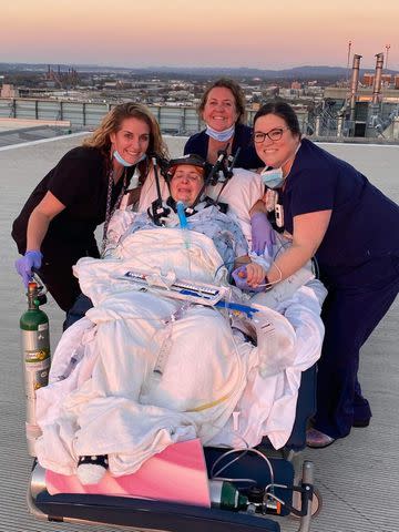 <p>Courtesy Christy Bullock</p> Christy Bullock with hospital staff watching the sunset over Children's Hospital in Birmingham.