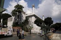 People walk past Kowloon Masjid and Islamic Centre in Hong Kong’s tourism district Tsim Sha Tsui