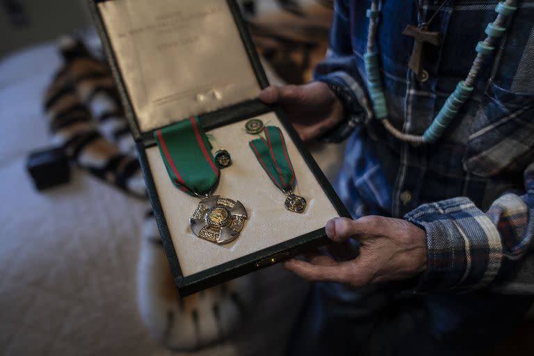 Sammy Basso shows the medal of knighthood given to him by ItalyÕs president, in Bassano del Grappa, Italy, March 10, 2022. Basso, 26, is believed to be the oldest surviving person with Hutchinson-Gilford Progeria syndrome, and with his degrees in natural science and molecular biology is helping with research efforts to discover a treatment and the secrets of aging. (Nadia Shira Cohen/The New York Times)