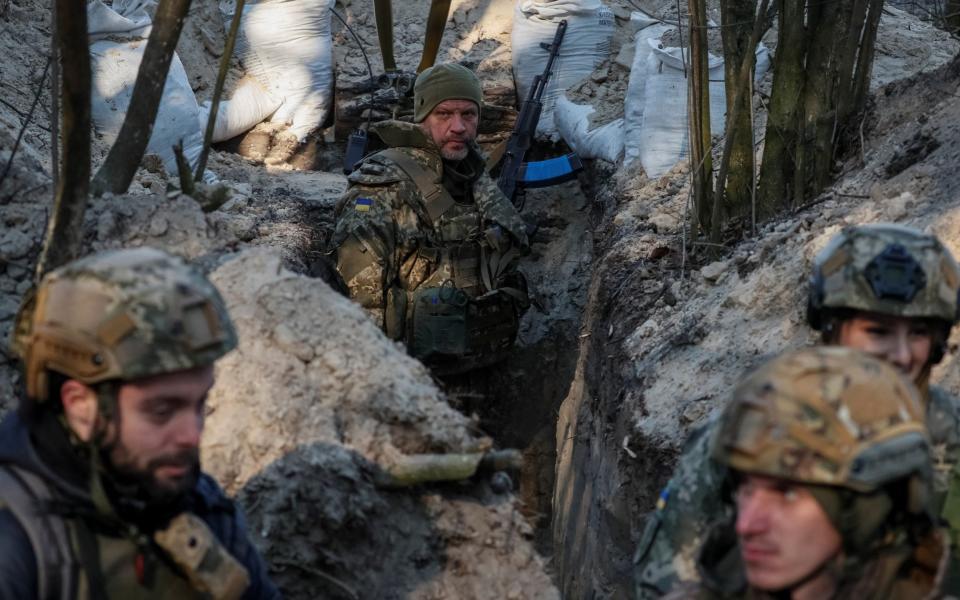 Ukrainian service members stand at a position on the front line in the north Kyiv region - Gleb Garanich/Reuters