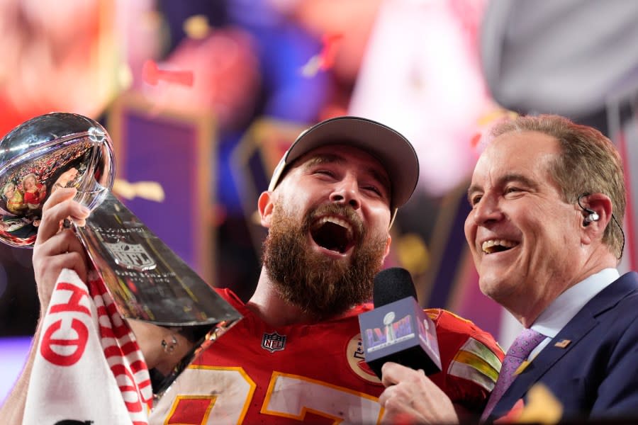 Kansas City Chiefs tight end Travis Kelce (87) celebrates while holding the Vince Lombardi Trophy after the NFL Super Bowl 58 football game against the San Francisco 49ers, Sunday, Feb. 11, 2024, in Las Vegas. The Chiefs won 25-22. (AP Photo/Ashley Landis)