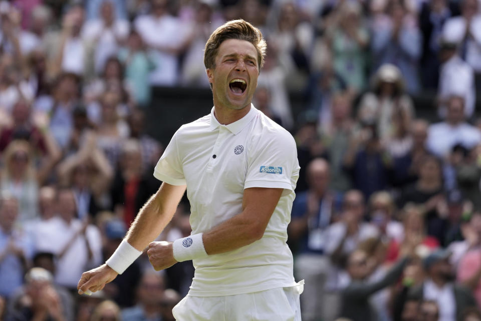 Britain's Liam Broady celebrates after beating Norway's Casper Ruud in a men's singles match on day four of the Wimbledon tennis championships in London, Thursday, July 6, 2023. (AP Photo/Kirsty Wigglesworth)